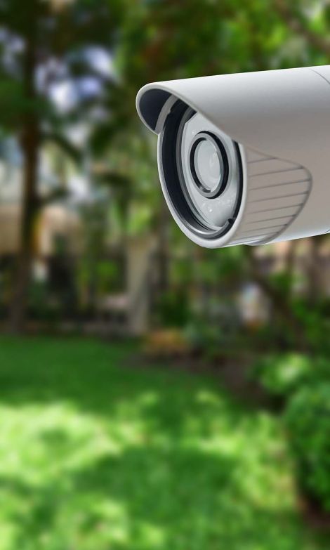 A residential home exterior featuring a security camera mounted near the entryway, highlighting a home video surveillance setup.