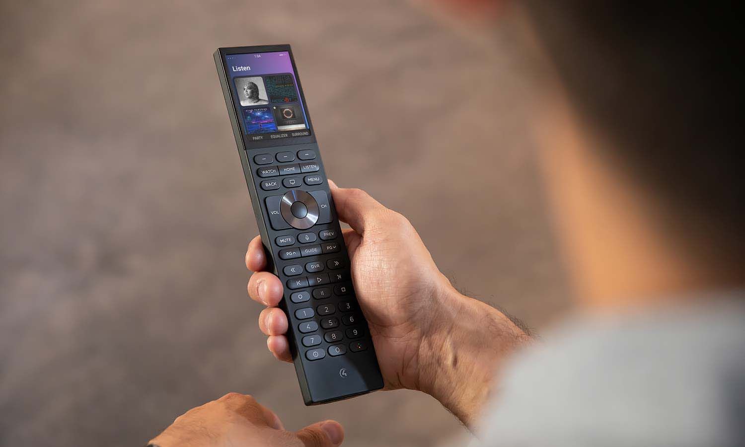 Control4 Touch panel in a able with a traditional home in the background