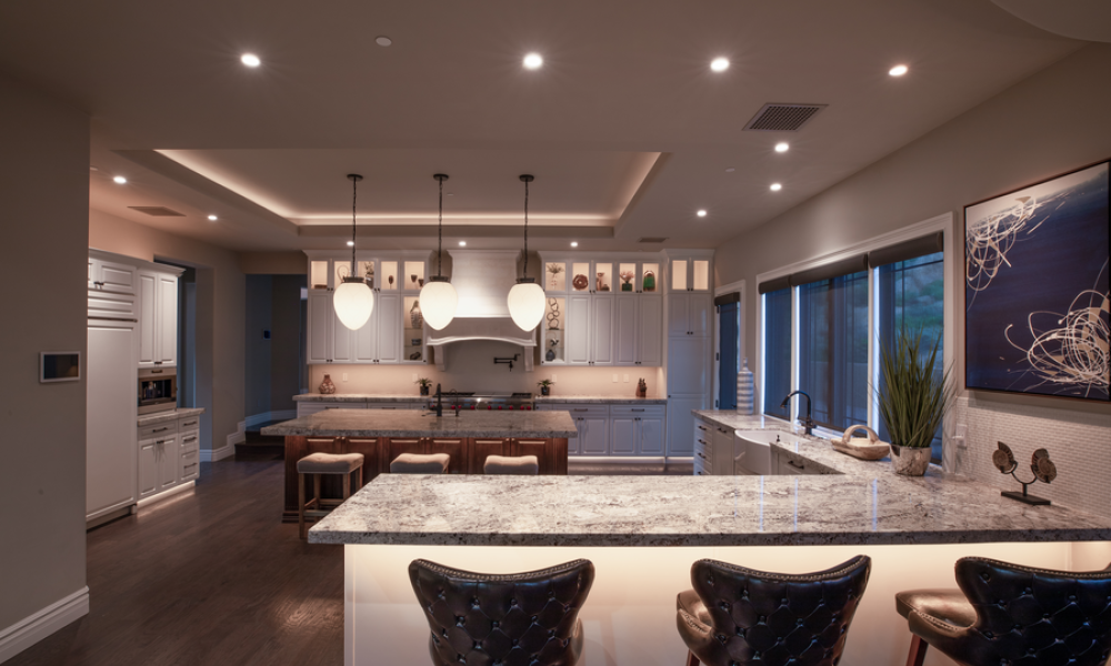 A kitchen with architectural, pendant, and ambient lighting.
