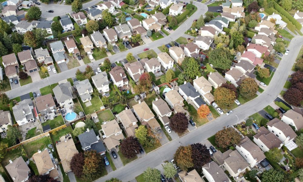 Aerial view of a suburban neighborhood with tree-lined streets.