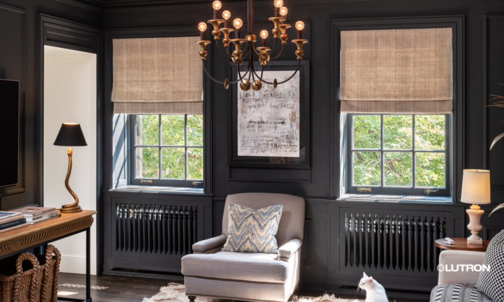 Lutron motorized Roman shades in a luxury dark-paneled room with a chandelier