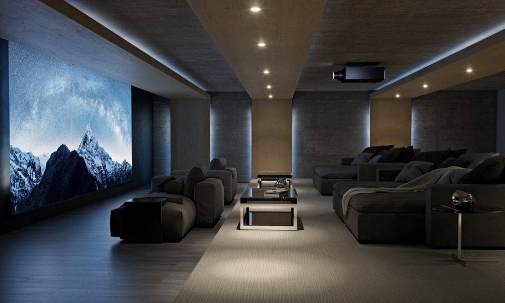 A luxury home theater featuring snowy mountains at night on the screen.