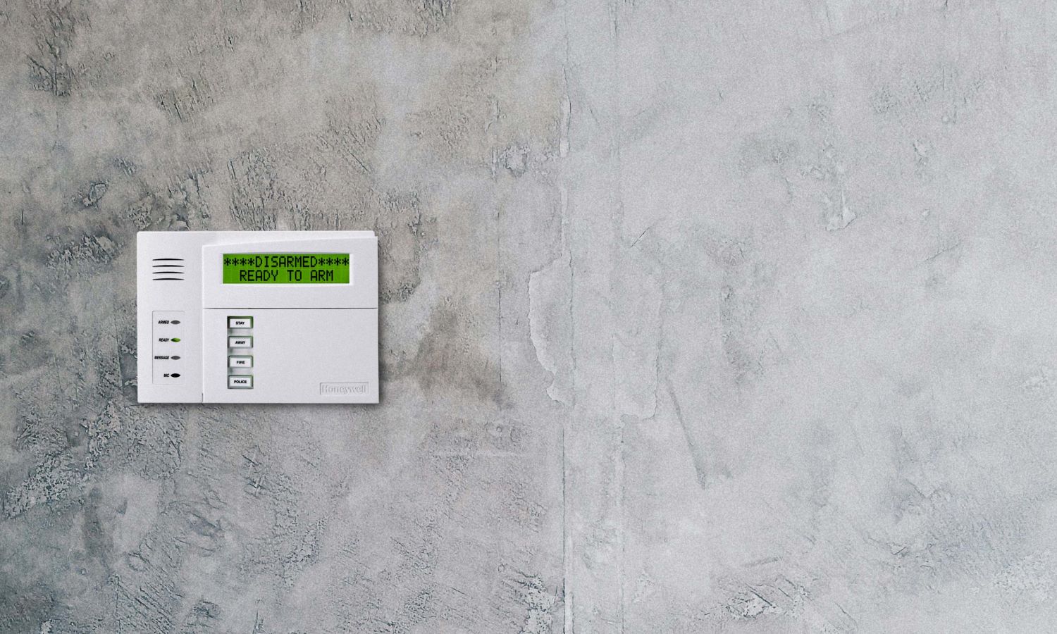 burglar alarm on a grey cement wall