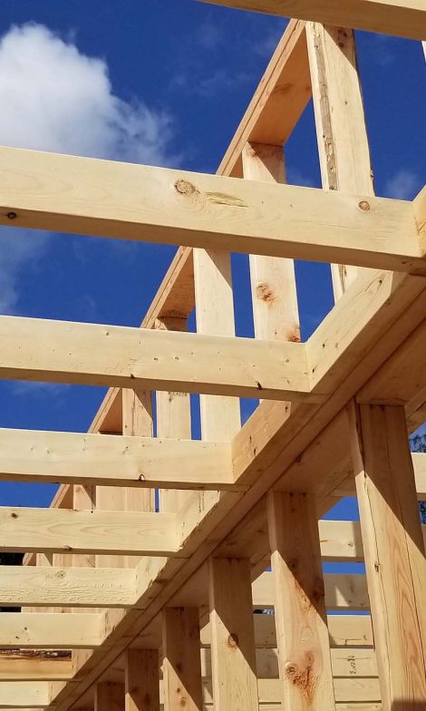 A construction scene at a building site with workers and piles of materials, representing a stock builders project in progress.